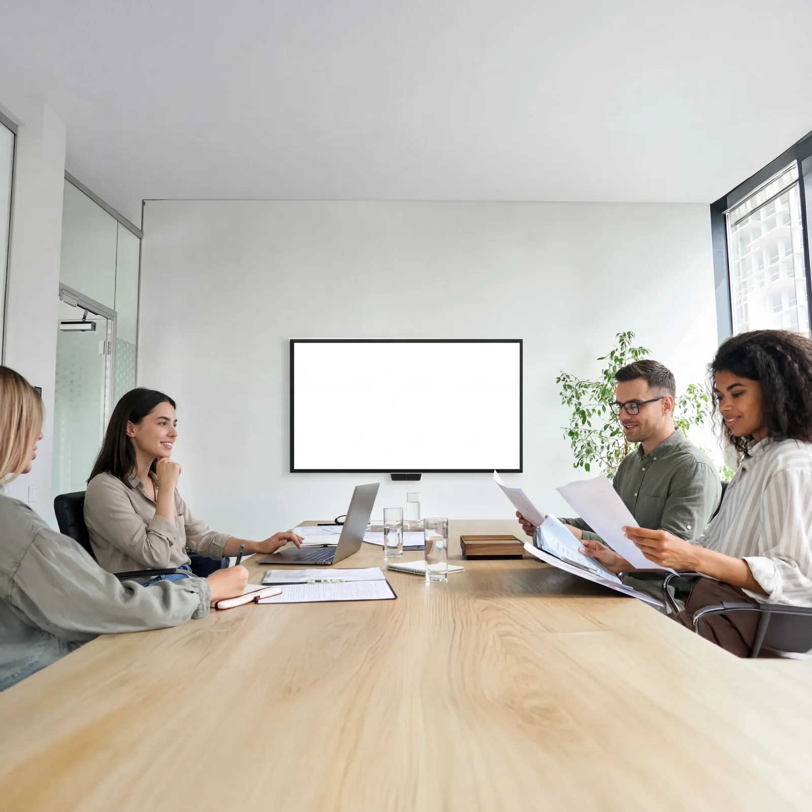 A development sales team working with the maquette in a meeting room
